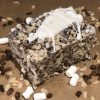 Frosted Chocolate Krispie treat surrounded by ingredients