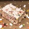 Frosted Fruity Krispie treat surrounded by ingredients