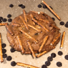 Sticky Nikki chocolate chip cookie topped with pretzel sticks, caramel, and sea salt