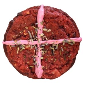 Pink Jesus inspired cookie - pink cookie with a pink cross on top and dusted with lavender buds.